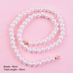 Detail of 50cm white pearl cake topper chain with 8mm beads on pink background