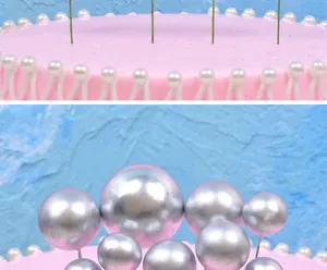 Close-up view of metallic silver decorative balls in various sizes for cake topping