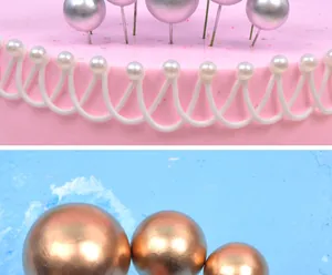 Macro close-up detail of metallic gold and silver cake topper balls for party cakes