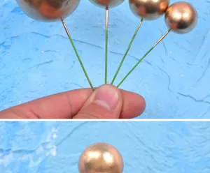 Detailed close-up view of shiny golden metallic spherical cake toppers for party decoration