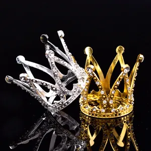 Gros plan de mini couronnes en strass or et argent pour gâteaux ou cheveux.