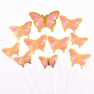 Detail view of pink butterfly cake toppers with elegant gold foil stamping edges