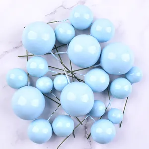 Bunch of baby blue foam ball cake toppers with flexible wire stems for baking