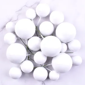 Detailed view of 20pcs white foam ball cake toppers in various sizes for baking