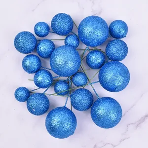 Detailed view of sparkly blue glitter decorative balls on wire picks for cake toppers