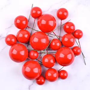 Close-up detail of mixed size glossy red foam balls for birthday cake decoration