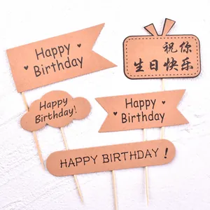 Detail view of various kraft paper birthday cake toppers with wooden sticks