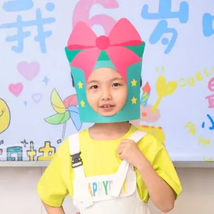 Child wearing creative green gift box shaped birthday party mask as a fun photo prop.