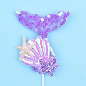 Detailed view of mermaid tail and shell cake topper with dimension labels