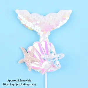 Detailed view of mermaid tail cake topper with seashell and starfish sequins