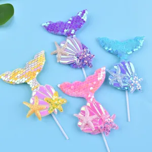 Sequin mermaid tail cake toppers with glitter starfish and shells for ocean party