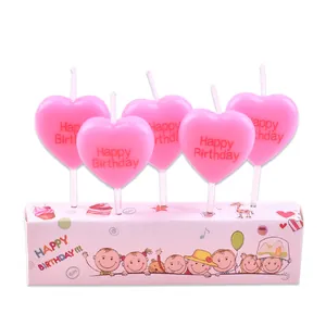Pink heart-shaped birthday candles with Happy Birthday text for cake decoration