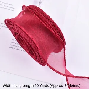 Detailed macro view of 4cm burgundy wavy edge organza ribbon showing delicate sheer texture