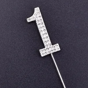 Close-up of sparkly silver rhinestone number 1 cake topper birthday decoration