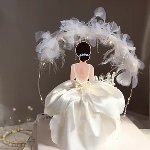 Detail showing the satin dress and LED feather arch of the goddess cake topper