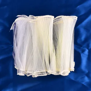 Close-up of pleated mesh cake border frill showing delicate texture and soft folds.