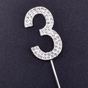 Macro view of silver rhinestone number 3 cake topper for birthday decorations