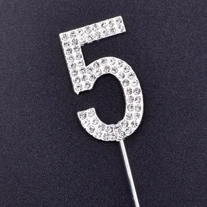 Close-up detail of silver rhinestone cake topper number 5 with sparkling clear gems