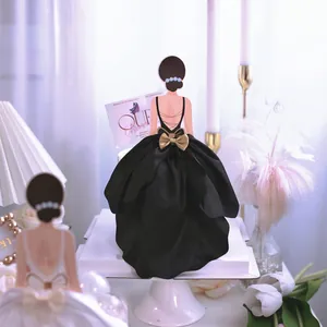 Elegant goddess silhouette cake topper with a voluminous black fabric gown detail