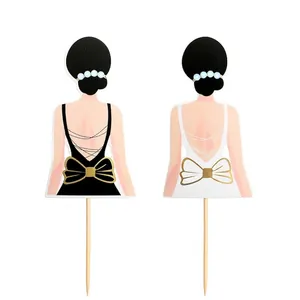 Pair of elegant lady back silhouette cake toppers featuring gold bows and pearls