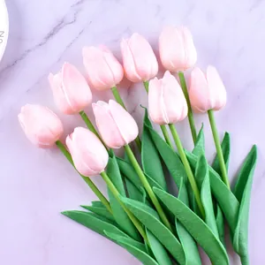 Detailed view of realistic pink tulip cake toppers with delicate petals and green stems