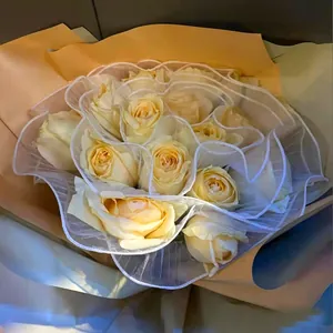 Close-up of elegant white wavy pleated mesh for professional flower bouquet packaging.
