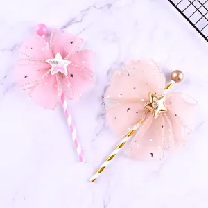 Detailed view of fairy mesh bow cake toppers with star accents on white marble surface