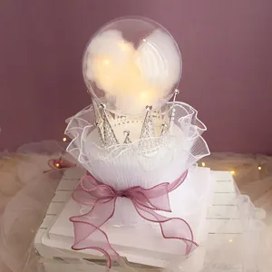 Detail view of a dreamy crystal ball cake topper with LED lights and silver crown