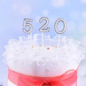 Close-up of elegant pearl-encrusted 520 number cake toppers with rhinestone borders