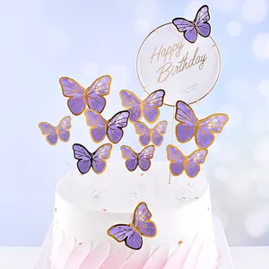 Detail shot of purple butterfly cake toppers with gold foil on a birthday cake.