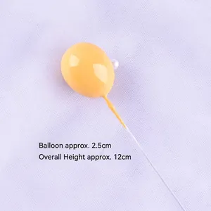 Detailed close-up of a 2.5cm yellow 3D balloon cake topper featuring a small pearl accent