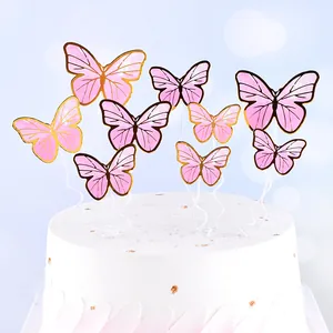 Detailed view of pink bronzing butterfly cake toppers on a white elegant frosted cake