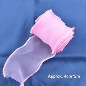 Close-up detail of soft pink organza mesh ribbon 4cm wide for birthday cake decoration
