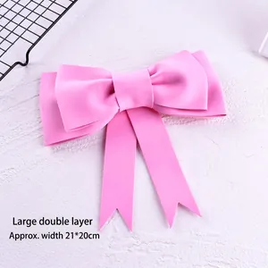 Close-up detail of a large double-layered pink EVA foam bow cake topper decoration