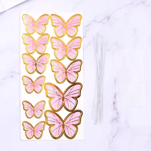 Detail view of pink gold-foiled butterfly cake topper set with wires and glue dots