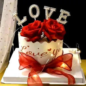 Elegant pearl LOVE cake topper set featuring red roses and warm LED string lights for romantic cakes