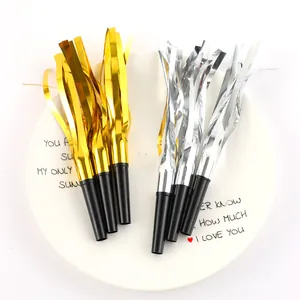 Detailed view of gold and silver metallic tinsel party blowouts on a decorative plate