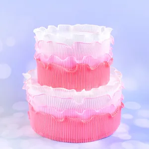 Detailed view of pink gradient ruffled cake border decoration with pleated texture
