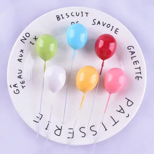 Close-up of colorful 3D mini balloon cake toppers for birthday party decoration