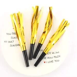 Close-up of four gold metallic party blowouts with black mouthpieces on a white plate