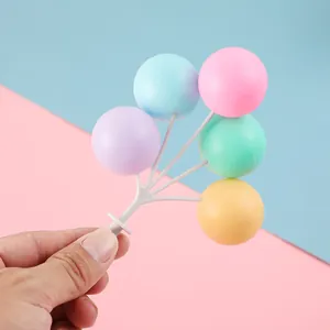 Detailopname van kleurrijke macaron-ballon taarttoppers voor verjaardagsfeestjes