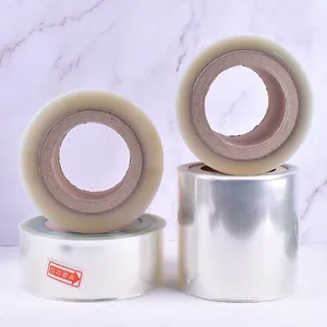 Detailed view of four transparent plastic mousse cake collar rolls for baking decoration