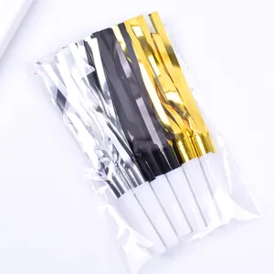 Detail of shiny gold, silver and black party blowouts whistles in clear packaging