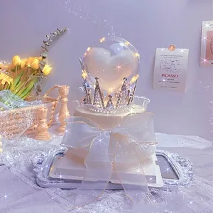 Dreamy cake topper set with light-up crystal ball, crown and ribbon bow