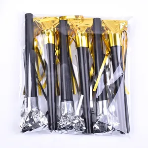 Detail of golden and silver party blowout whistles in transparent plastic packaging