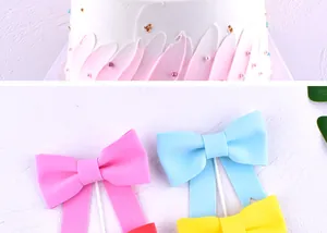 Close-up detail of colorful matte bow tie cake toppers for birthday party decoration