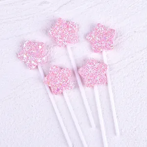 Set of 5 pink glitter star cake toppers with white sticks for birthday party decoration.