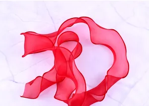 Detail view of red sheer organza ribbon with elegant wavy edges for cake decoration