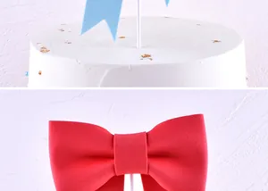 High-definition close-up of red bow-tie and blue flag cake toppers decoration details