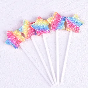 Detail shot of rainbow glitter star cake toppers for birthday party decoration